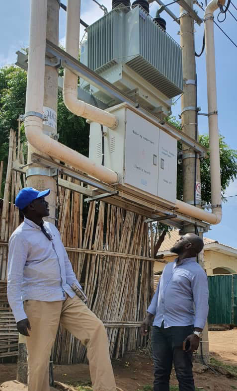 Deng, left, inspects electrical equipment with a colleague in Juba, South Sudan.