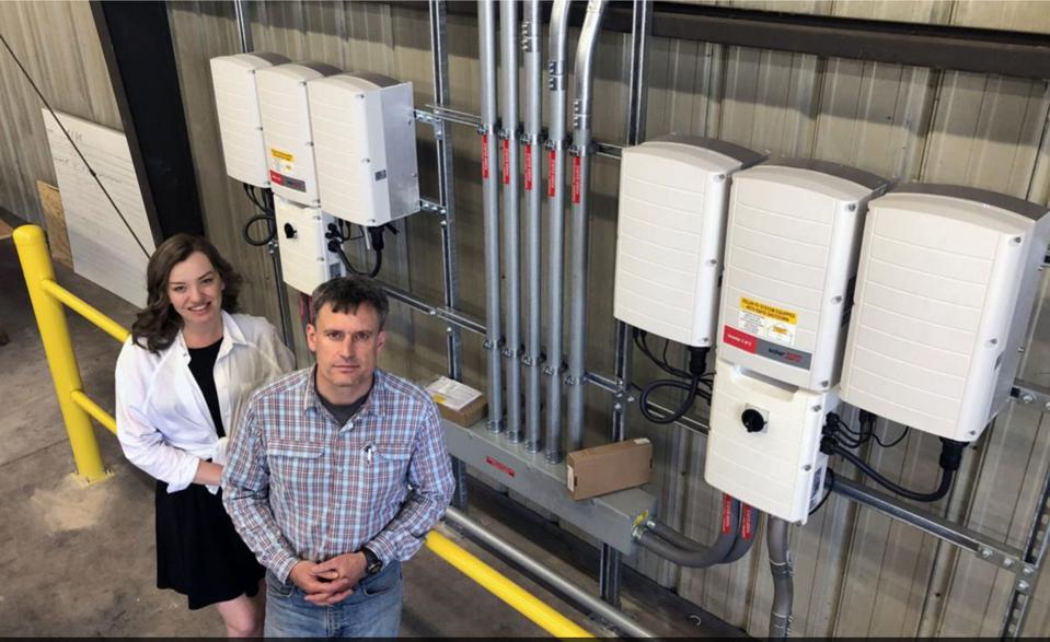 Keena Mullins and Zach Drennen, co-founders of Revolt Energy that is now part of Nitro Construction Services pose at solar site in West Virginia. BOB SAUNDERS, OF THE DAILY MAIL WV